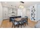Open dining area featuring stylish lighting, a dining table set, and a seamless transition to the modern kitchen at 1905 N Alabama St, Indianapolis, IN 46202