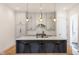 A modern kitchen featuring a large island, stainless steel appliances, and stylish pendant lighting at 1905 N Alabama St, Indianapolis, IN 46202