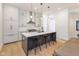 Modern kitchen with an island and seating, stainless steel appliances, and hardwood floors at 1905 N Alabama St, Indianapolis, IN 46202