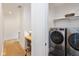 Modern laundry room with front-loading washer and dryer and a wooden desk at 1905 N Alabama St, Indianapolis, IN 46202