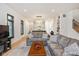 Inviting living room with hardwood floors, neutral-colored furniture, and an open view to the kitchen at 1905 N Alabama St, Indianapolis, IN 46202