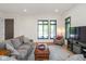 Comfortable living room with large windows, modern furniture, and hardwood floors at 1905 N Alabama St, Indianapolis, IN 46202