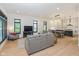 Bright living room with hardwood floors, modern furniture, and open floor plan to the kitchen at 1905 N Alabama St, Indianapolis, IN 46202