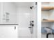 Bright bathroom featuring a tiled shower and floating shelves with towels at 1905 N Alabama St, Indianapolis, IN 46202