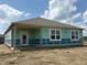 View of a newly constructed home featuring bright white windows and a glass-paned door, ready for customization at 201 Holly Ln, Greenfield, IN 46140
