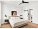 Bright main bedroom with a plush bed, modern ceiling fan, and elegant décor. The space also boasts a sliding barn door at 2015 Yandes St, Indianapolis, IN 46202