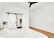 A bright main bedroom leads to the ensuite, featuring a sliding barn door, natural light, and white walls at 2015 Yandes St, Indianapolis, IN 46202
