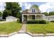 Inviting exterior of a two-story home with a covered porch and detached two-car garage at 206 W Wall St, Advance, IN 46102