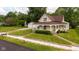Charming vintage home featuring a welcoming front porch, a well-manicured lawn, and a detached two-car garage at 206 W Wall St, Advance, IN 46102