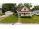 Charming vintage home featuring a welcoming front porch, a well-manicured lawn, and a detached two-car garage at 206 W Wall St, Advance, IN 46102