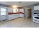 Well-lit kitchen with white cabinets, red countertops, and a door to the backyard at 206 W Wall St, Advance, IN 46102