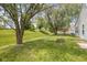 Spacious backyard featuring mature trees and a fire pit for outdoor gatherings at 2080 Bridlewood Dr, Franklin, IN 46131