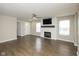 Bright living room with a ceiling fan, fireplace, and wood-look flooring at 2080 Bridlewood Dr, Franklin, IN 46131