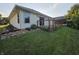 Back of the house with a wooden deck, complemented by beautiful landscaping and healthy lawn at 21 Watson Dr, Trafalgar, IN 46181