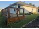 Wooden deck with cable railing and landscaping, surrounded by a lush green lawn and greenery at 21 Watson Dr, Trafalgar, IN 46181
