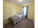 Cozy bedroom featuring carpet floors, a single bed, and a window with curtains at 21 Watson Dr, Trafalgar, IN 46181