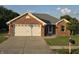 Charming brick home with a well-manicured lawn, inviting entrance, and attached two-car garage at 21 Watson Dr, Trafalgar, IN 46181