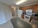 Spacious kitchen showcasing white appliances, wooden cabinets, and light-colored flooring at 21 Watson Dr, Trafalgar, IN 46181