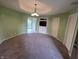 Neutral living room features plush carpeting, modern lighting, and an entertainment center with a built-in TV shelf at 21 Watson Dr, Trafalgar, IN 46181