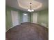 Neutral living room features plush carpeting, modern lighting, and three entryways at 21 Watson Dr, Trafalgar, IN 46181