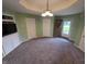 Neutral living room features plush carpeting, modern lighting, and a view into the front yard through the front door at 21 Watson Dr, Trafalgar, IN 46181