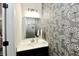 Stylish powder room with floral patterned accent wall at 21536 Gisborne Dr, Noblesville, IN 46062