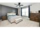Comfortable bedroom featuring panel wall, ceiling fan, bench, and large window at 21536 Gisborne Dr, Noblesville, IN 46062