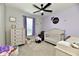 Charming bedroom featuring lavender walls, neutral furnishings, and a ceiling fan for added comfort at 21536 Gisborne Dr, Noblesville, IN 46062