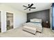 Cozy bedroom featuring panel wall, ceiling fan, bench, and soft carpet at 21536 Gisborne Dr, Noblesville, IN 46062