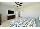 Modern bedroom with ceiling fan, TV, dresser, and access to bathroom and closet at 21536 Gisborne Dr, Noblesville, IN 46062