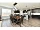 Spacious dining area with modern light fixture and wood table at 21536 Gisborne Dr, Noblesville, IN 46062