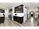 Modern kitchen featuring sleek, dark cabinetry and gray wood flooring at 21536 Gisborne Dr, Noblesville, IN 46062