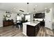 Open-concept kitchen with a large island, dining area, and stainless steel appliances at 21536 Gisborne Dr, Noblesville, IN 46062