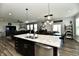 Open-concept kitchen with a large island, dining area, and stainless steel appliances at 21536 Gisborne Dr, Noblesville, IN 46062