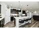 Modern kitchen with stainless steel appliances, dark cabinets, and a granite-topped island at 21536 Gisborne Dr, Noblesville, IN 46062