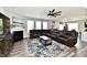 Spacious living room with fireplace and large leather sectional at 21536 Gisborne Dr, Noblesville, IN 46062