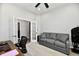 Bright office space with a ceiling fan and a comfortable-looking gray couch at 21536 Gisborne Dr, Noblesville, IN 46062