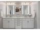 Bright bathroom featuring double sinks and lighted mirrors at 225 N New Jersey St # 52, Indianapolis, IN 46204