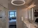 This bathroom features a modern vanity with marble countertop and views of the city at 225 N New Jersey St # 52, Indianapolis, IN 46204