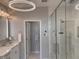 Bright bathroom features a glass shower, modern vanity, and stylish light fixtures at 225 N New Jersey St # 52, Indianapolis, IN 46204