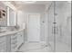 This bathroom features white marble tile and an enclosed glass shower at 225 N New Jersey St # 52, Indianapolis, IN 46204