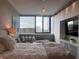 Cozy bedroom with large window and skyline views, with an integrated entertainment center at 225 N New Jersey St # 52, Indianapolis, IN 46204