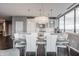 Bright dining room features a modern chandelier, sleek table and chairs, and open layout to kitchen at 225 N New Jersey St # 52, Indianapolis, IN 46204