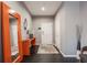 Modern entryway with console table, orange mirror frame and hardwood floors at 225 N New Jersey St # 52, Indianapolis, IN 46204