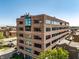 An exterior view of the building with large windows and lush landscaping at 225 N New Jersey St # 52, Indianapolis, IN 46204