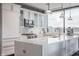 Bright kitchen featuring white cabinets, quartz countertops, stainless steel appliances, and large window at 225 N New Jersey St # 52, Indianapolis, IN 46204