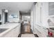 Bright kitchen flowing into an office space, featuring white cabinets, quartz counters, and stainless steel appliances at 225 N New Jersey St # 52, Indianapolis, IN 46204