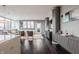 Open-concept living room with hardwood floors, modern decor, and large windows at 225 N New Jersey St # 52, Indianapolis, IN 46204