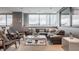 Cozy living area featuring a leather sofa, accent chairs, and large windows for ample natural light at 225 N New Jersey St # 52, Indianapolis, IN 46204