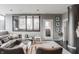 Modern living room with an inviting leather sectional, stylish decor, and city views at 225 N New Jersey St # 52, Indianapolis, IN 46204
